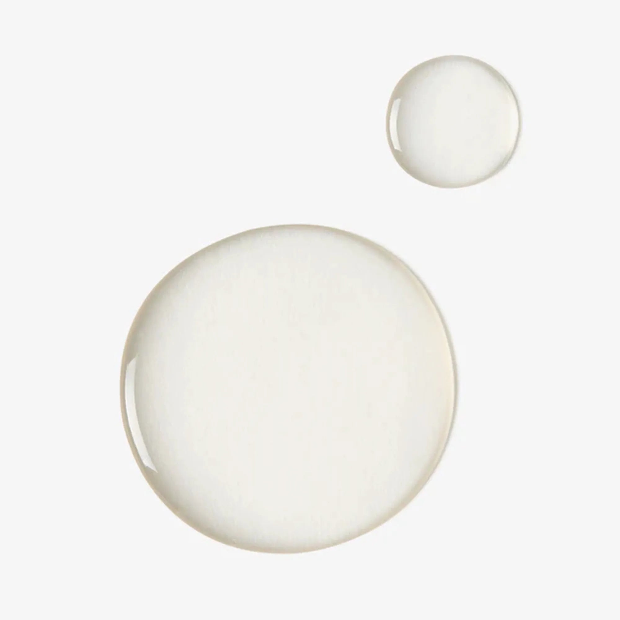 Clear drops of Bohemia Skin mandelic serum on a white background, clean skincare texture