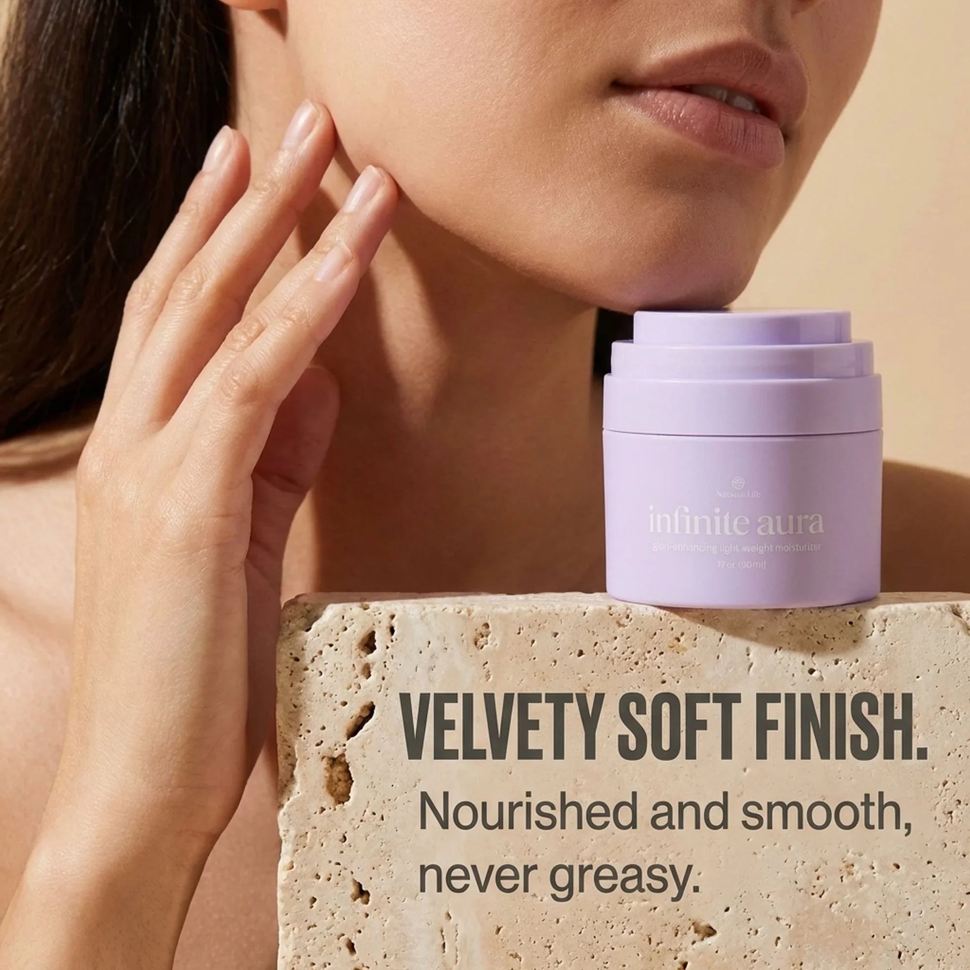 Woman touching face near Bohemia Skin Infinite Aura moisturizer, text highlights velvety soft finish.